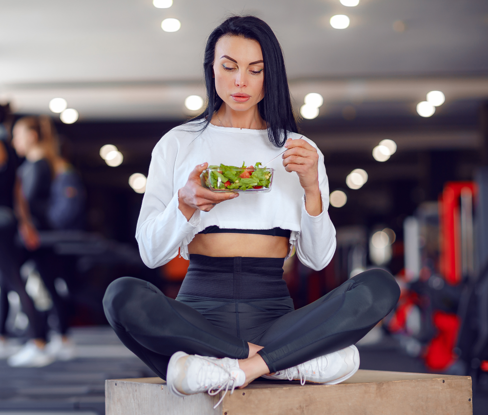 Woman eating a fresh salad for healthy eating, nutrition, and wellness.