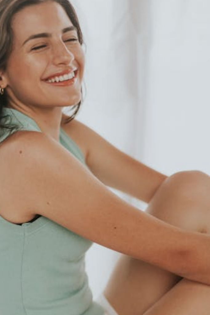 Female smiling warmly, expressing positivity and confidence.