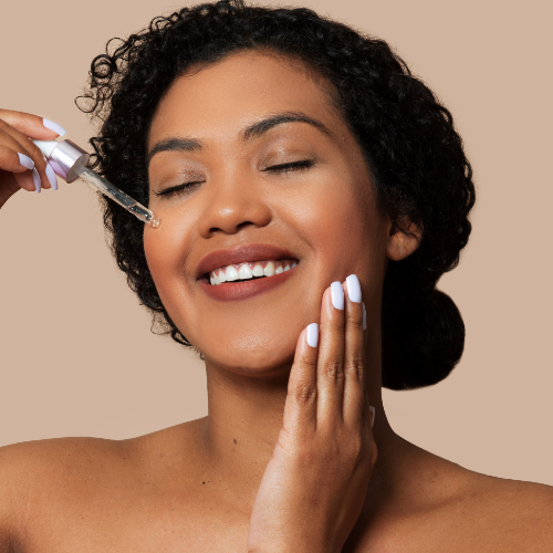Glowing woman performing facial skincare steps for healthy, radiant skin.