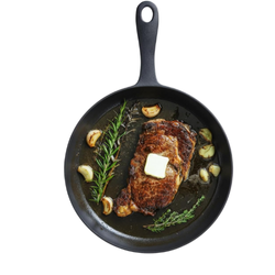 Flambo iron skillet with a sleek, black finish, displayed on a clean surface, highlighting its durable, heavy-duty design for versatile cooking and searing.
