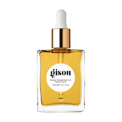 Gisou Honey Infused Hair Oil in a sleek amber bottle with a black cap, displayed on a clean surface, highlighting its nourishing, honey-infused formula for healthy, shiny hair.
