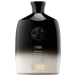 Oribe Gold Lust Repair & Restore Shampoo in an elegant gold and white bottle, displayed on a clean surface, highlighting its luxurious formula for strengthening and revitalizing hair.