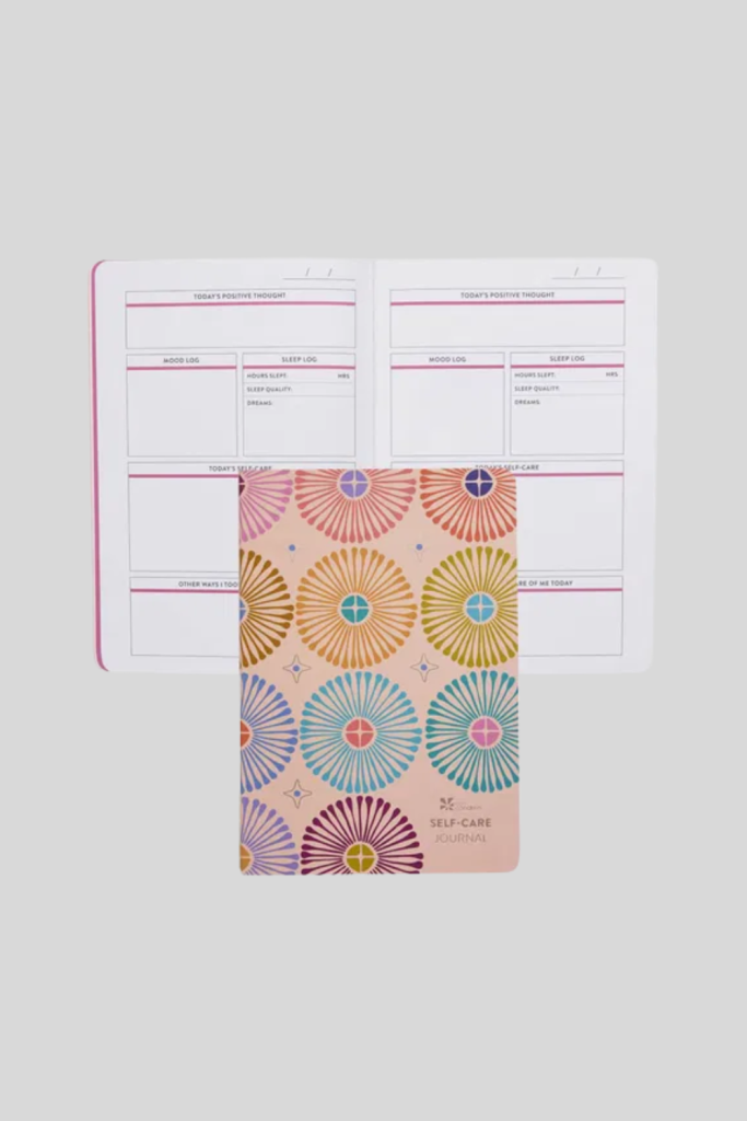 PetitePlanner Self Care Journal with pastel cover and gold lettering.