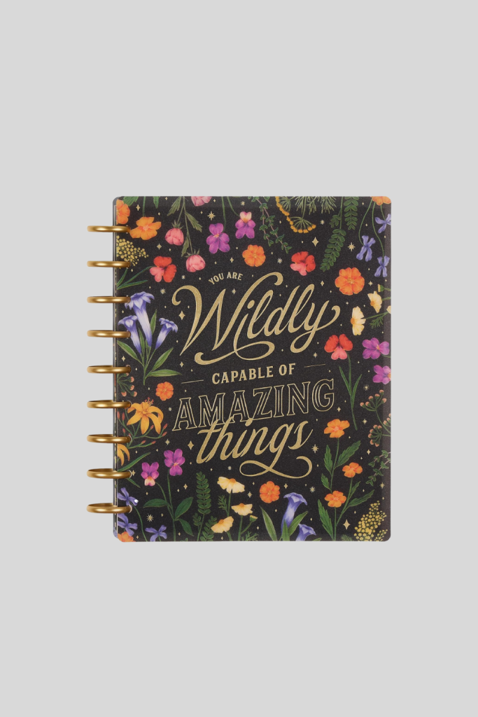 The Happiness Planner 2026 with elegant hardcover design and gold-foil lettering.
