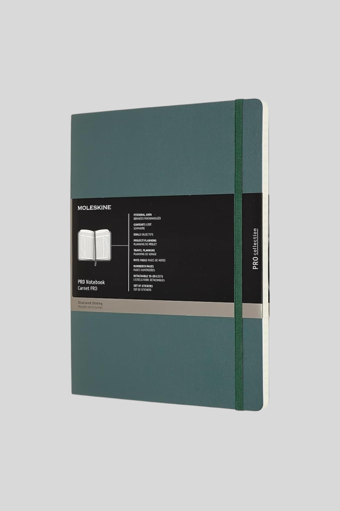 Moleskine Professional Planner open on a desk, showing structured weekly and monthly layouts for scheduling, task management, and goal planning.