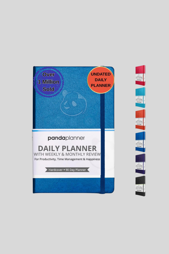 Panda Planner open on a desk, showing daily, weekly, and monthly layouts for productivity, goal-setting, and habit tracking.