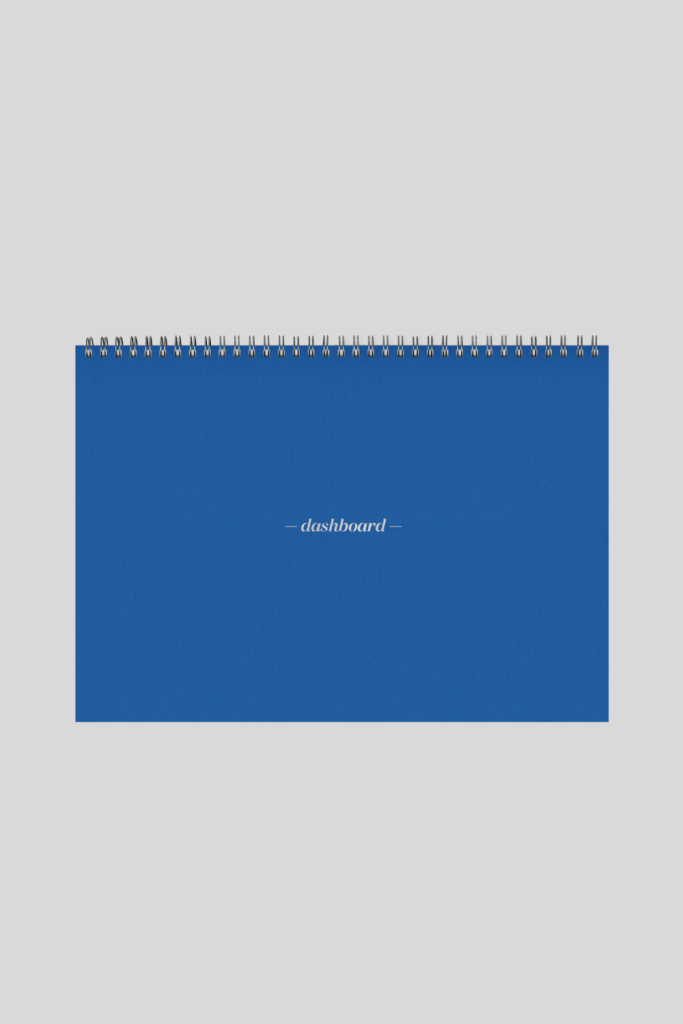 Ink+Volt Planner open on a desk, showing daily, weekly, and monthly layouts for goal-setting, productivity, and task management.