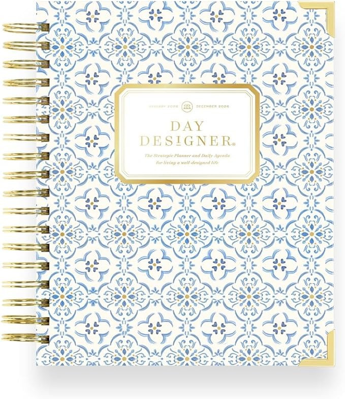 Day Designer planner open to a daily layout with sections for schedule, to-do lists, priorities, and notes, designed for organized planning, productivity, and time management.